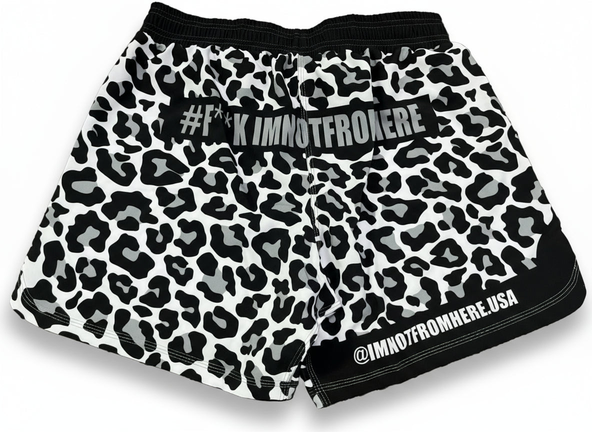 Leopard print shorts with branding on a textured surface